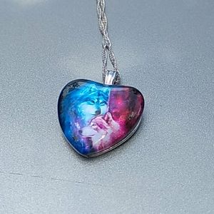 Heart necklace with mother and cub wolf.